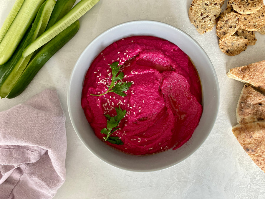 Baked beets on a cookie sheet with parchment paper.